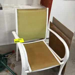 Patio armchair. Features a white-finished metal frame with a tan mesh sling seat and back. Designed for outdoor use. Stackable. Background items not i