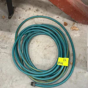 Garden hose. Features a green vinyl construction with a yellow stripe accent. Includes threaded end fittings.