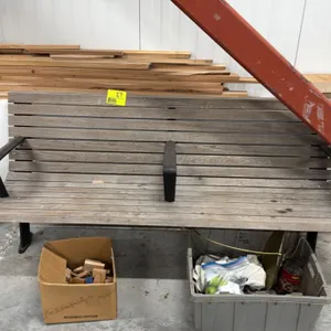 Wooden bench. Features a slatted wood seat and backrest design on a metal frame with three integrated armrests, including a center divider. 6'L. Mount