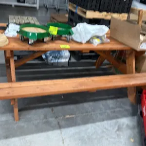 Unbranded wooden picnic table. Features traditional A-frame design with attached bench seating on both sides. 8'L. Tabletop contents not included.