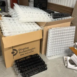 Display Technologies assorted beverage case shelf dividers and bottle glides. Includes a bulk quantity of modular plastic bottle organizing racks in w