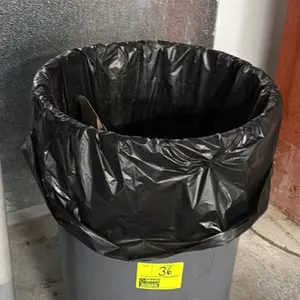 Unbranded poly trash bin. Features a round gray plastic design. 30"H. Contents not included.