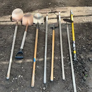 8 Mixed Garden Tools Including Shovels, Rakes, and Hoe