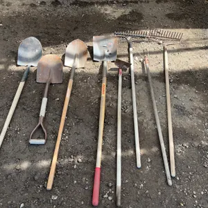 Garden Tools Including Shovels, Rakes, Hoe, and Cultivator