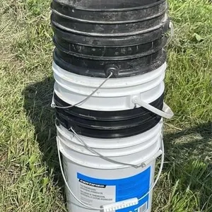 Stack of 18.9L empty buckets
