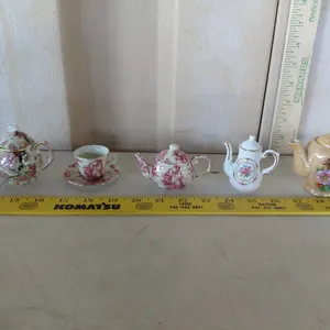 4 Miniature Teapots & 2 Cup/Saucer (Chipped)