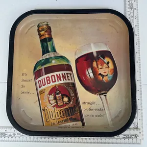 Metal advertising serving tray features graphics for Dubonnet Aperitif Wine