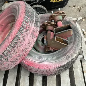OFFSITE - 2 tires on 6 bolt rims with 2 hubs. Size LT245/75R16, holding air.
