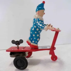 Vintage Tin Wind-Up Toy Featuring A Clown Riding