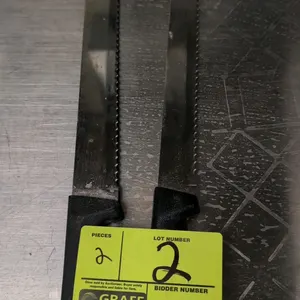 Serrated bread knife. Features a 9" stainless steel blade with a serrated edge and a molded black handle.