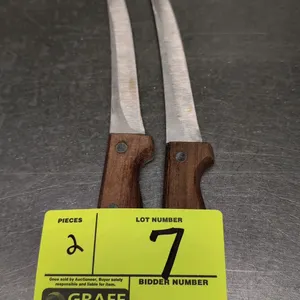 Stainless steel filet knife. Features a 6" curved stainless steel blade and a wood handle secured with two rivets.