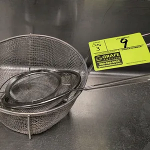 Assorted metal kitchen strainers. Includes (1) large wire mesh deep basket strainer with a long handle and front hook, (1) fine mesh strainer with dua