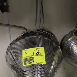 Lot of (2) assorted metal cap/chinois strainers. Includes (1) perforated metal conical strainer and (1) fine mesh conical strainer. Both units feature