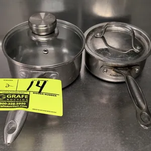 Assorted stainless steel sauce pans. Includes (1) Cuisinart saucepan with a stainless steel lid and (1) Tramontina saucepan with a glass lid. Features
