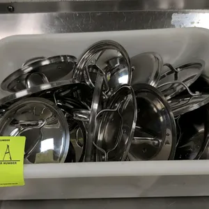Assorted stainless steel cookware lids. Includes 17 lids in various sizes and styles. Features Cuisinart and other assorted brands. Constructed of pol