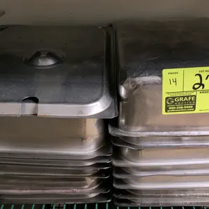 Lot of 1/2-size stainless steel insert pans and lids. Features 4" depth. Includes 2 stainless steel lids with utensil notches. 14 pieces total.