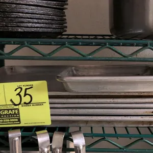 Aluminum sheet pan lot. Includes five 17"x13" sheet pans and one 13"x9.5" sheet pan. Features aluminum construction with wire-beaded rims. Background 