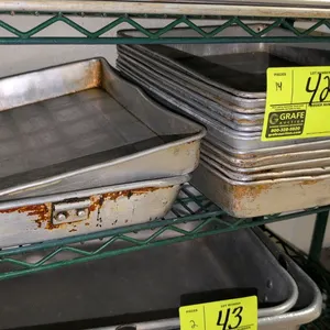 Aluminum sheet pan set. Includes (13) 12"x16"x2" aluminum sheet pans and (1) 12"x18"x2" aluminum sheet pan. Racking and background elements not includ