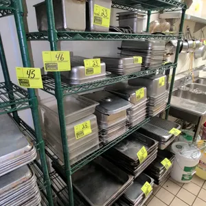Green epoxy-coated wire shelving rack. Features an 8-tier adjustable shelf design. 48"x14"x75". Stationary leveling feet. Contents not included.
