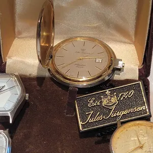 JULES JURGENSEN & More Watches. Jules Jurgensen Slimline Quartz Hunting Case watch is missing the bow, doesn't run and presumably needs a batt