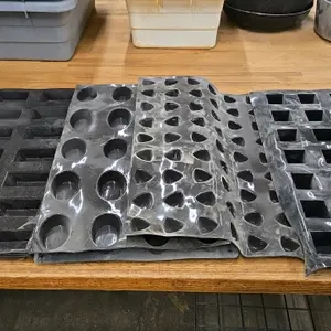 Lot of (7) assorted flexible silicone rubber baking molds. Includes sheets with various cavity shapes including rectangular, oval, rounded triangle, a