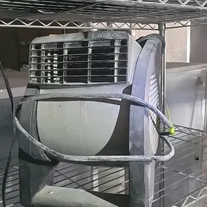 Lasko pivoting utility air mover. Features an adjustable blower head, integrated carry handle, and standard three-prong power cord. Shelving and other