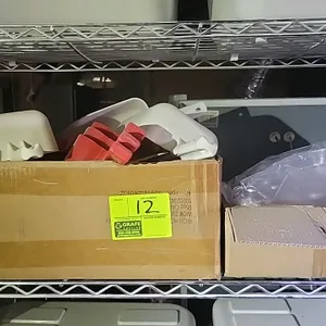 Bulk lot of assorted scoops. Includes white plastic scoops, red plastic scoops, and clear plastic scoops in various sizes. Suitable for commercial or 