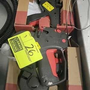 Monarch 1131 hand-held price labeler. Features a single-line print design with an ergonomic red squeeze trigger and dark gray plastic body. Includes o