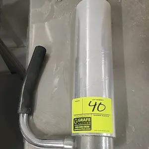 Handheld stretch wrap dispenser. Features a chrome-plated metal frame with dual black rubber hand grips. Designed for manual pallet wrapping and packa