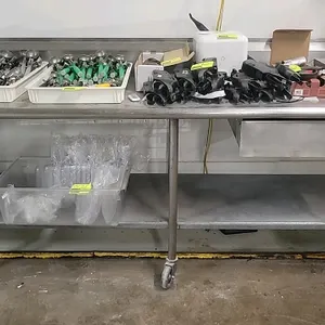 Portable stainless steel work table. Features a backsplash, undershelf, and a single drawer. Measuring 96"W x 30"D x 39"H. Mounted on casters. Content