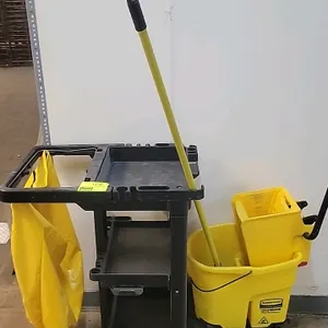 Rubbermaid Commercial Products janitor cart. Features a 3-shelf plastic construction with integrated tool hooks and holders. Includes a yellow zippere
