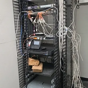 Electronics server rack with integrated networking equipment. Includes HPE ProLiant DL380 Gen10 server, Aruba 2930M JL322A switch, Tripp Lite B020-U08
