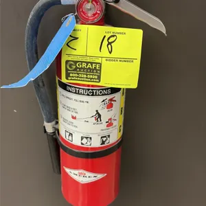 Amerex ABC dry chemical fire extinguisher. Features a hand-portable design with discharge hose, pull pin with safety seal, and integrated pressure gau
