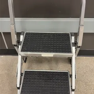 Front Line 2-step folding ladder. Features a lightweight aluminum frame, two wide steps with slip-resistant black treads, and an integrated safety han
