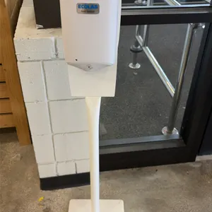Ecolab hand sanitizer dispenser station. Features a touchless automatic dispenser mounted on a white floor stand with a square base.