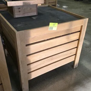 Bradley produce display table. Features a wood slat-sided design with a black top deck. Includes a removable raised wooden display tier equipped with 