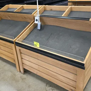 Bradley wooden produce display bin. Features a two-tier slanted display design with a divided top shelf and clear plastic front product retainer. Incl