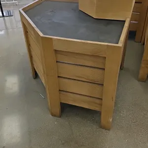 Bradley Wood hexagonal produce display. Features natural wood slat-style side panels, a black display deck, and a raised step-up riser tier. 36"W x 36