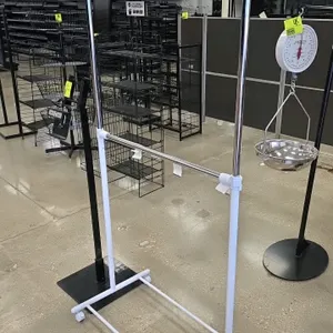 Package lot containing (1) Twist-Ease metal produce bag stand and (1) portable 2-tier garment rack. The Twist-Ease stand features a black metal post a