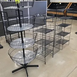 Assorted wire retail display racks. Includes (1) 4-tier spinning wire basket display rack on a mobile 5-star base, (1) wire dump bin, and multiple mul