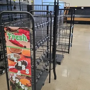 Assorted metal merchandiser display racks. Package lot includes (1) 4-tier rack with 'Fresh Herbs & Spices' side graphic, (1) 3-tier round wire basket