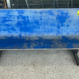 Wooden bench. Features a molded plywood seat with a blue finish and black metal T-base legs. 6'L. Shopping carts in background not included.