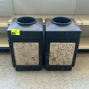 Polyethylene waste receptacle. Features a durable black molded plastic body with decorative aggregate stone-look side panels. Equipped with a removabl