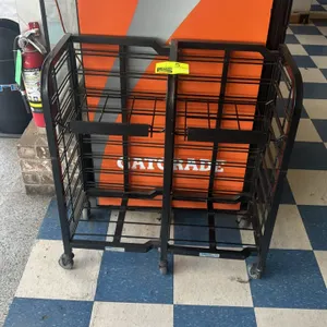 Metal 2-tier portable merchandiser. Features dual-sided wire display shelves. Mounted on swivel casters. 31"x14".