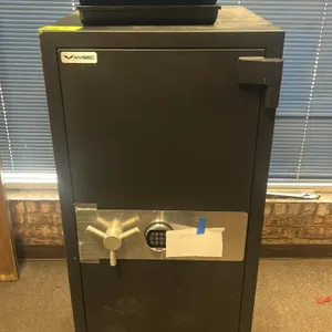 AMSEC metal office safe. Features electronic keypad lock, three-spoke chrome handle, and textured finish. Combination is included. Dimensions: 25"x29"