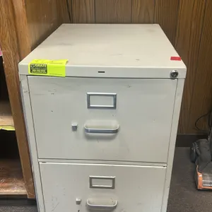 Two metal 2-drawer vertical filing cabinets. Features putty-colored finish, integrated pull handles, and label holders. Note: Keys are not included.