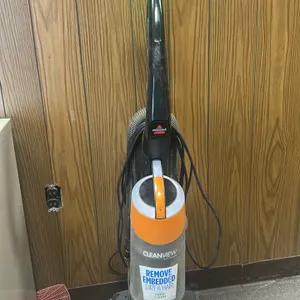 Bissell Cleanview upright vacuum cleaner. Features multi-cyclonic suction system, OnePass technology, and a bagless clear dirt canister. Equipped with