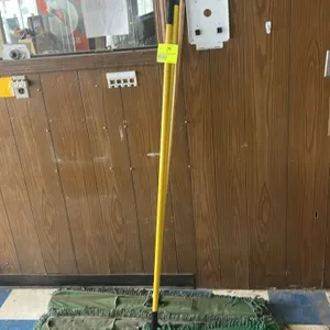 Cintas commercial dust mop lot. Includes two handles (one yellow composite and one wood) and three green loop-end dust mop heads mounted on metal wire