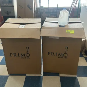 Primo Water 1-gallon refillable poly water jugs. Features semi-translucent plastic construction with integrated carry handles and blue screw caps. Inc