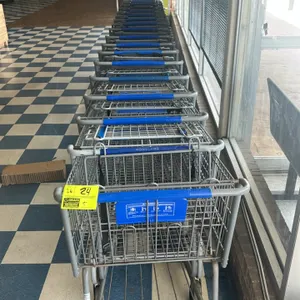 Metal wire shopping cart. Features a grey finish, blue plastic handle sleeve, a folding child seat with a blue plastic backrest and safety strap, and 